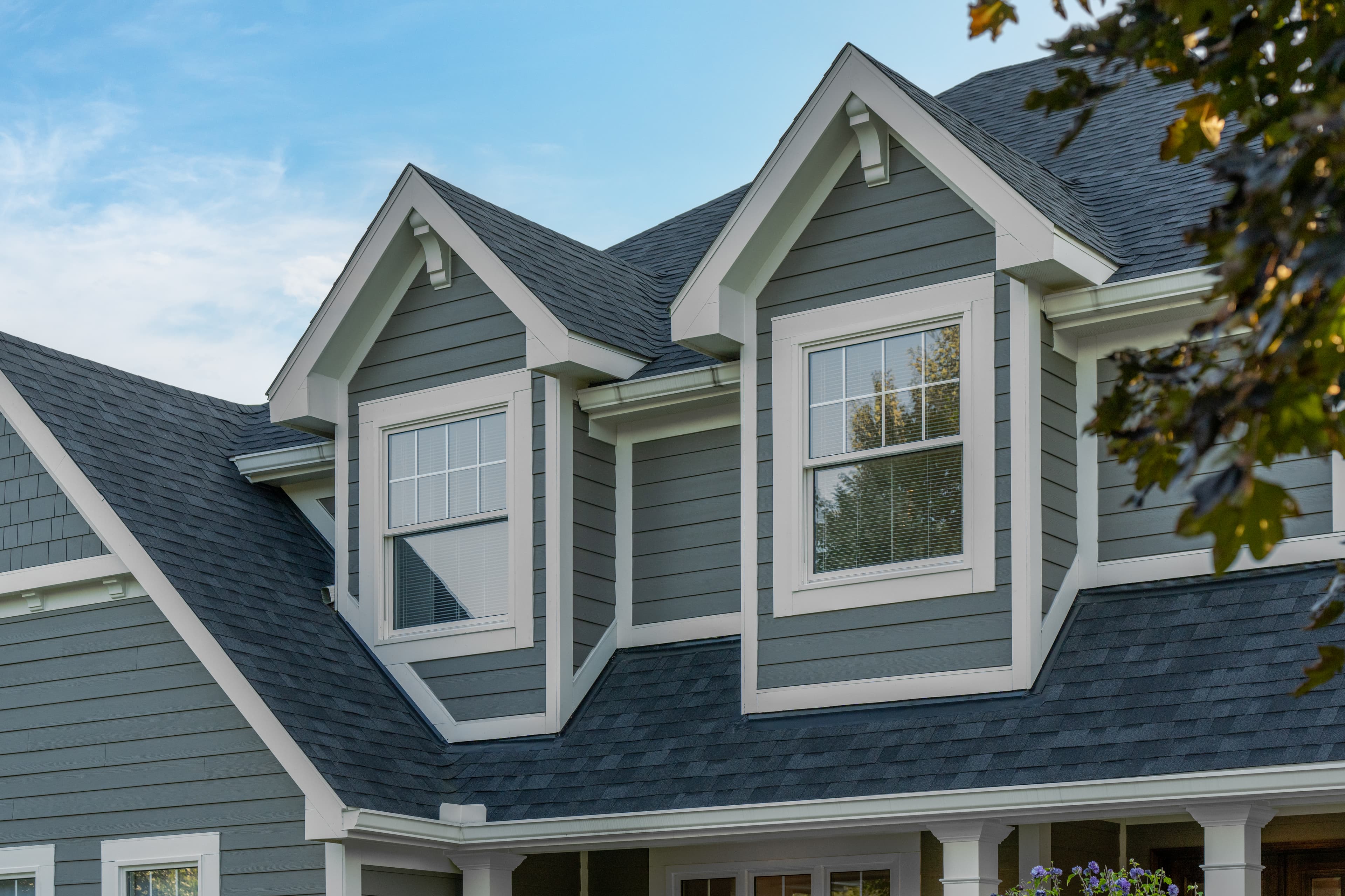 Selecting siding and trim for a whole house re-side: detail of a house clad in Aged Pewter Hardie Plank and Arctic White Hardie Trim Detail of a house clad in Aged Pewter Hardie Plank and Arctic White Hardie Trim